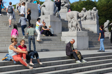 OSLO, NORWAY - AUGUST 2, 2015: People visit gardens and Vigeland Installation in Frogner Park, Oslo. 212 sculptures around the park were all designed by artist Gustav Vigeland.のeditorial素材
