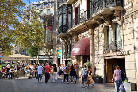 BARCELONA, SPAIN - OCTOBER 7, 2021: People visit Passeig de Gracia street in Eixample district, Barcelona, Spain. Passeig de Gracia is famous for its modernist architecture and high street fashion shopping.のeditorial素材