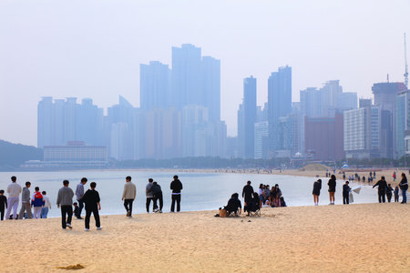 BUSAN, SOUTH KOREA - MARCH 29, 2023: People visit Haeundae beach in Haeundae district of Busan, South Korea.のeditorial素材