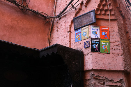 MARRAKESH, MOROCCO - FEBRUARY 20, 2022: Le Routard hotel recommendation badges on a wall of a riad...