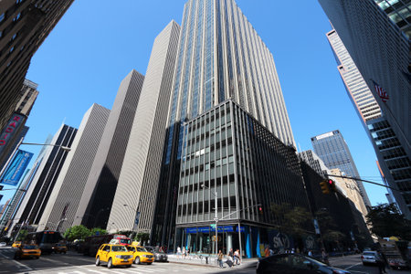 NEW YORK, USA - JULY 5, 2013: Street level view looking up at 6th Avenue in New York. The avenue is...