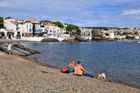 CADAQUES, SPAIN - OCTOBER 5, 2021: People visit picturesque fishing harbor of Cadaques in Catalonia region of Spain. The town is located in Alt Emporda county of Catalonia, Spain.のeditorial素材