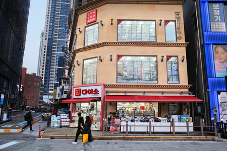 BUSAN, SOUTH KOREA - MARCH 29, 2023: People walk by Daiso discount store in Haeundae district in Busan city, South Korea.のeditorial素材