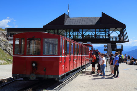 SCHAFBERG, AUSTRIA - AUGUST 3, 2022: People board the Schafbergbahn steam train to the top of mount Schafberg in Salzkammergut region of Austria. It is a metre gauge cog railway.のeditorial素材