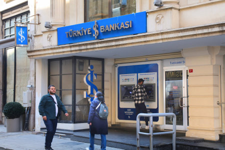 ISTANBUL, TURKEY - MARCH 25, 2023: Person visits Turkiye Bankasi branch also known as Isbank. It is...