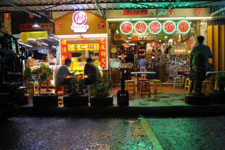 KUALA LUMPUR, MALAYSIA - MARCH 17, 2024: People visit Restoran Ruby restaurant on a rainy night in...