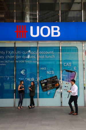 SINGAPORE CITY, SINGAPORE - MARCH 13, 2024: People visit UOB Bank branch in Singapore. United...