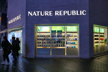 SEOUL, SOUTH KOREA - APRIL 5, 2023: People visit Nature Republic Korean beauty store in Myeongdong shopping district in Seoul by night.のeditorial素材