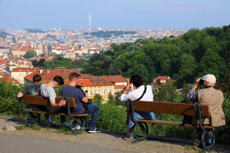 PRAGUE, CZECH REPUBLIC - MAY 4, 2024: Tourists visit a viewpoint terrace in Strahov Garden...