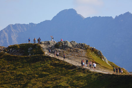 TATRA MOUNTAINS, POLAND - SEPTEMBER 9, 2023: People walk the red trail Swinica mountain in Tatrzanski Park Narodowy (Tatra National Park) in Poland.のeditorial素材