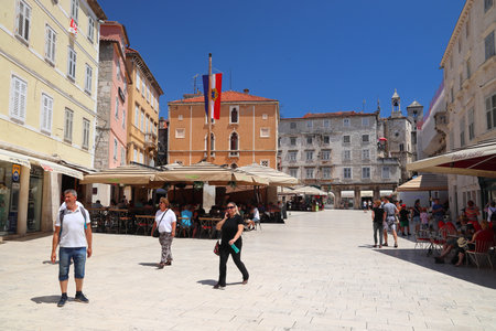 SPLIT, CROATIA - JULY 20, 2019: People visit Narodni Trg city square in Split. Croatia had 18.4...
