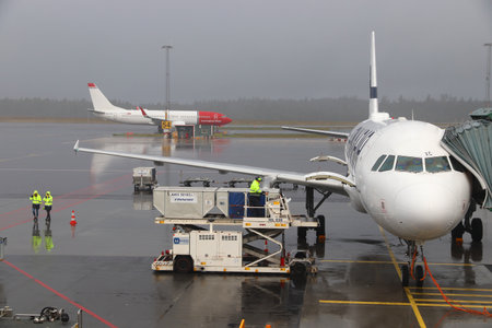 GOTHENBURG, SWEDEN - AUGUST 28, 2018: Norwegian Air Shuttle Boeing 737 and Finnair Airbus at rainy Gothenburg Landvetter airport in Sweden.のeditorial素材