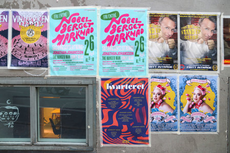 STOCKHOLM, SWEDEN - AUGUST 23, 2018: Posters for concerts and other events on a wall in Sodermalm district of Stockholm, Sweden.のeditorial素材