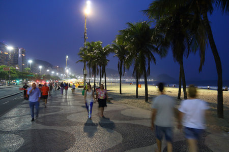 RIO DE JANEIRO, BRAZIL - OCTOBER 18, 2014: People visit evening Copacabana beach in Rio de Janeiro.のeditorial素材