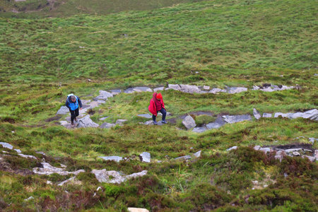 CONNEMARA, IRELAND - JUNE 27, 2024: Tourists hike to Diamond Hill in Connemara National Park. Rainy weather in County Galway, Ireland.のeditorial素材