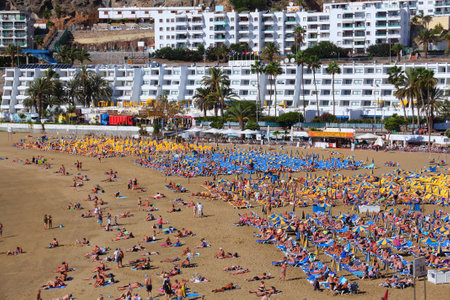 GRAN CANARIA, SPAIN - DECEMBER 2, 2015: People visit Puerto Rico Beach on a sunny day in Gran Canaria, Spain.のeditorial素材