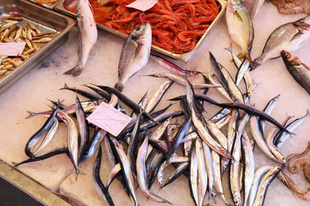 Catania fish market, known locally as La Pescheria. Fresh seafood market in Catania city, Sicily, Italy. Costardella (Atlantic saury) fish prices.の写真素材