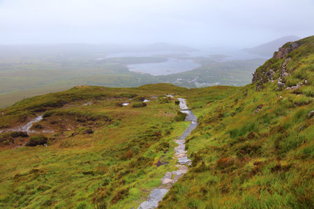 Mountain hiking trail to Diamond Hill in Connemara National Park. Rainy weather in County Galway, Ireland.の写真素材