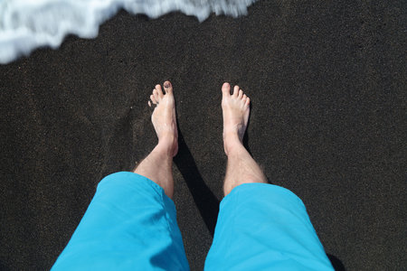 Standing on black volcanic sand of Ajuy beach in Fuerteventura island of Canary Islands, Spain.の写真素材