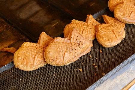 Japanese taiyaki fish shaped sweet cookies with red bean paste filling. Street food of Japan.の写真素材