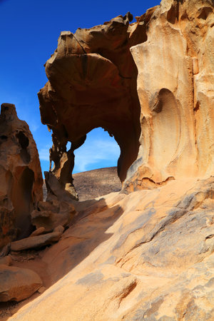 Arco de las Penitas natural rock arch. Natural tourist attraction in Fuerteventura island of Canary Islands, Spain.の写真素材