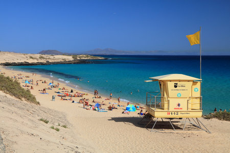 FUERTEVENTURA, SPAIN - DECEMBER 1, 2024: People visit the beach in Corralejo in Fuerteventura island of Canary Islands, Spain.のeditorial素材