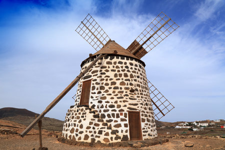Historic windmill in Fuerteventura island of Canary Islands, Spain. Volcanic landscape of Molino de Villaverde.の写真素材