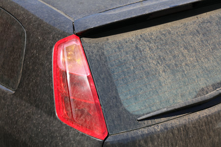 Dirty car needs a wash. Small car with dirt on rear windshield.の写真素材