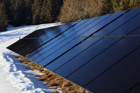 Solar panels mounted on frame in next to a remote mountain lodge in Poland. Photovoltaic energy...
