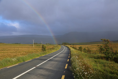 Road in County Mayo in Ireland. Summer view with rainbow.の写真素材