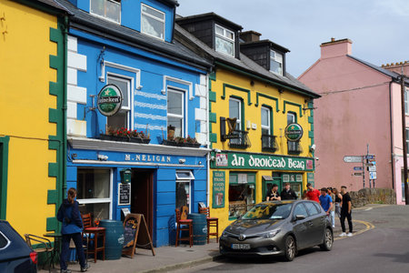 DINGLE, IRELAND - JULY 2, 2024: People visit colorful main street of Dingle town in Dingle Peninsula in County Kerry, Ireland.のeditorial素材