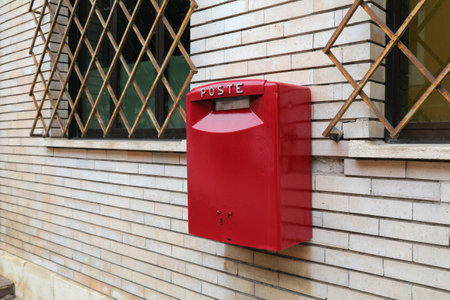 Generic public postbox in Italy. Italian red mailbox street view.の写真素材
