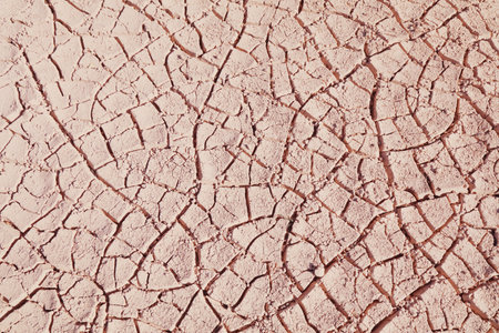Dry cracked mud texture. Background of dried earth. Drought in Colombia.の写真素材