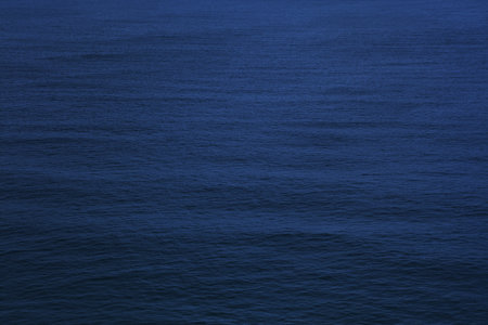 Dark water surface. Atlantic Ocean background. Night water dark texture.