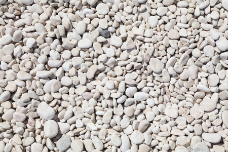 White stone beach background in Sardinia island, Italy. White zen stone texture.