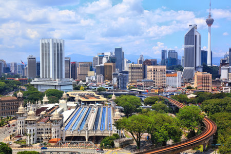 Kuala Lumpur city skyline with LRT public transportation train in foreground. Kuala Lumpur, Malaysia.の写真素材