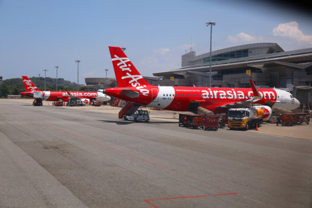 KOTA KINABALU, MALAYSIA - MARCH 8, 2024: Multiple Airbus A320neo aircraft of low cost airline AirAsia parked at Kota Kinabalu International Airport.のeditorial素材