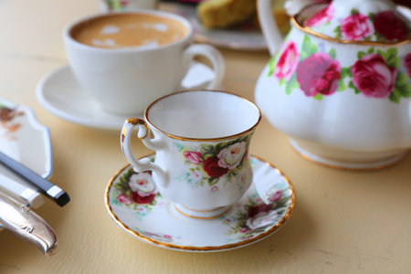 Fancy vintage style rose themed coffee cup in a cafe in South Korea. Flower design teacup.の写真素材