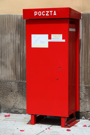 WROCLAW, POLAND - JULY 6, 2014: Post box of Poczta Polska in a street of Wroclaw Old Town. Poczta Polska is the national public postal service operator in Poland.のeditorial素材