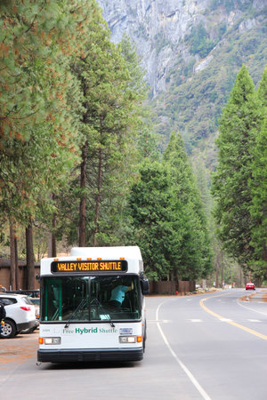 YOSEMITE, USA - APRIL 11, 2014: Yosemite Valley visitor shuttle bus in Yosemite National Park, California. It is a free hybrid public transportation solution.のeditorial素材