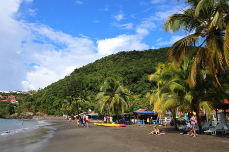 GUADELOUPE, FRANCE - DECEMBER 3, 2019: People spend beach vacation in Malendure Beach of Bouillante on Guadeloupe island. Guadeloupe has 650,000 annual visitors.のeditorial素材