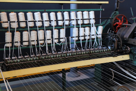 Textile factory machinery. Old loom machine. Historic textile industry.の写真素材