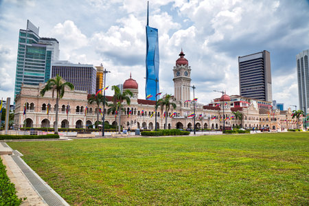 Sultan Abdul Samad Building in Kuala Lumpur, Malaysia, with Moorish architecture, copper domes and city skyline in background. Merdeka Square public space in Kuala Lumpur.の写真素材