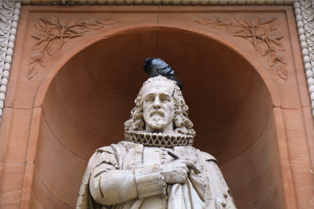 LONDON, UK - JULY 9, 2024: Sculpture of Francis Bacon by William Theed in the facade of 6 Burlington Gardens of Royal Academy of Arts in Mayfair area of London, UK.のeditorial素材