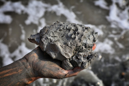 Dead Sea mud in Israel. Dead Sea mud handful. It has medicinal properties and is used in skin care cosmetics. Mud lump.の写真素材