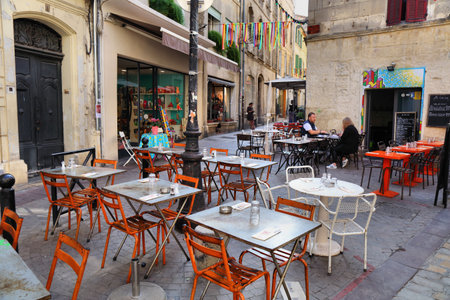 ARLES, FRANCE - OCTOBER 1, 2021: People visit an old town restaurant in Arles, France.のeditorial素材