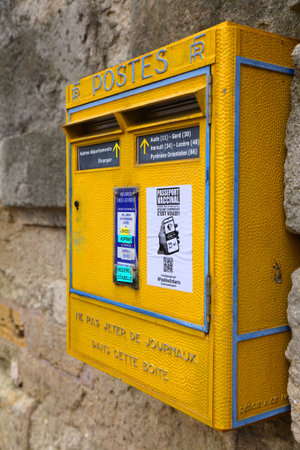 BEZIERS, FRANCE - OCTOBER 3, 2021: Public yellow mailbox of La Poste in Beziers, France. La Poste is the French public postal service.のeditorial素材
