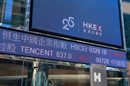 HONG KONG, CHINA - NOVEMBER 17, 2025: Hong Kong Stock Exchange HKEX stock prices ticker scrolling display showing Tencent stock and HSCEI index.のeditorial素材