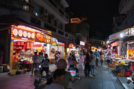 GUANGZHOU, CHINA - NOVEMBER 9, 2025: People visit street markets of Shawan ancient town (Shawanzhen) in Guangzhou city in Guangdong region of China.のeditorial素材