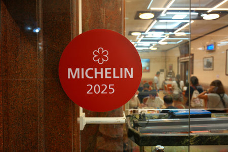 GUANGZHOU, CHINA - NOVEMBER 9, 2025: Michelin Guide star award in the door of Xinji Seafood Restaurant in Guangzhou city in Guangdong region of China.のeditorial素材